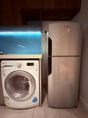 a refrigerator and a washing machine in a room at D'Majestic Place by Roomy in Kuala Lumpur
