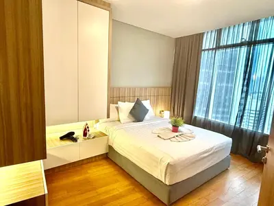 a bedroom with a bed and a large window at Vortex Apartment Near By Klcc in Kuala Lumpur