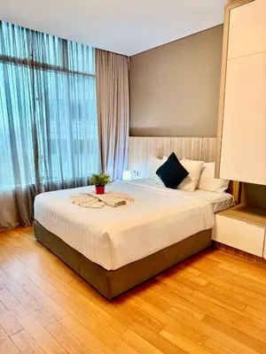 a bedroom with a large bed in front of a window at Vortex Apartment Near By Klcc in Kuala Lumpur