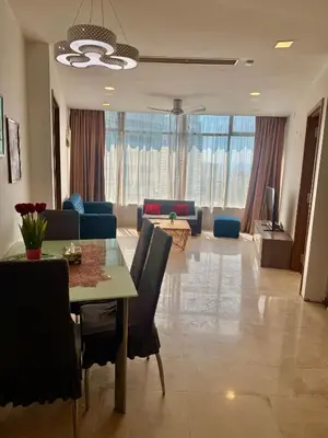 a living room with a dining table and a living room at Vortex Apartment Near By Klcc in Kuala Lumpur