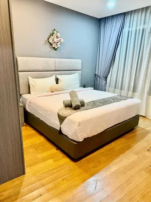 a bedroom with a large bed with a large window at Vortex Apartment Near By Klcc in Kuala Lumpur