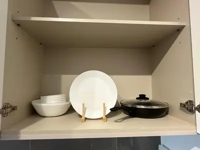 a kitchen shelf with a plate and a pan and bowls at AGILE SKY HOME Near Pavilion with TRX and GOLF View Including Swimming Pool in Kuala Lumpur