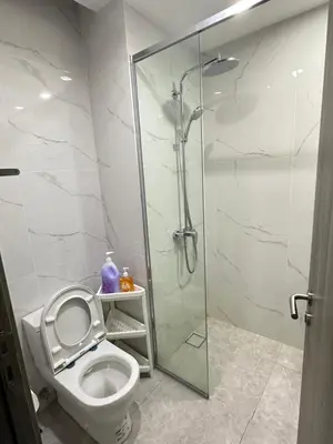 a bathroom with a toilet and a glass shower at AGILE SKY HOME Near Pavilion with TRX and GOLF View Including Swimming Pool in Kuala Lumpur