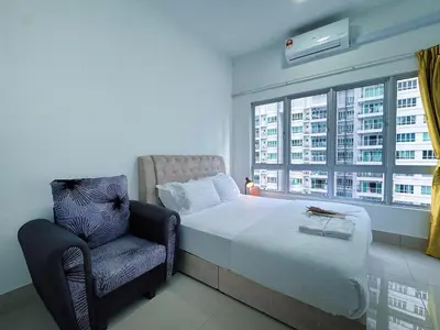 a bedroom with a bed and a chair and a window at Razak City Fully Air-Con Suite Sungai Besi Kuala Lumpur 57100 in Kuala Lumpur