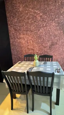 a dining table with two chairs and a vase on it at Razak City Fully Air-Con Suite Sungai Besi Kuala Lumpur 57100 in Kuala Lumpur