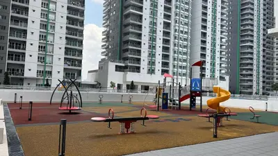a playground with play equipment in a city with tall buildings at Razak City Fully Air-Con Suite Sungai Besi Kuala Lumpur 57100 in Kuala Lumpur