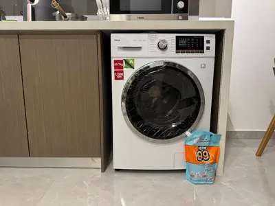a washing machine sitting under a counter in a kitchen at Agile Bukit Bintang TRX KL by Lilbean Space - 2B1R in Kuala Lumpur