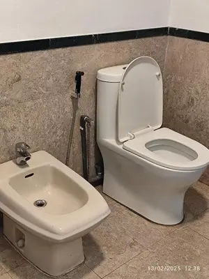 a bathroom with a toilet and a sink at The Marvelous Suites at Times Square Kuala Lumpur in Kuala Lumpur