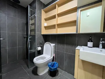 a bathroom with a toilet and a sink and a shower at The Colony Infinitum By Couple Stay in Kuala Lumpur