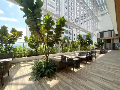 a cafeteria with tables and chairs in a building at The Colony Infinitum By Couple Stay in Kuala Lumpur