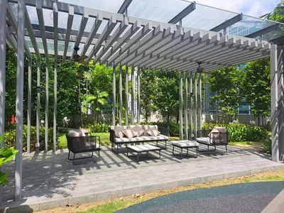 a pergola with chairs and a bench and a table at Agile marigold Suite KL in Kuala Lumpur
