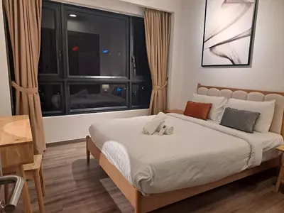 a bedroom with a large bed with a window at Agile marigold Suite KL in Kuala Lumpur