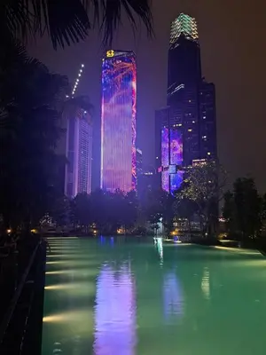 a city skyline at night with a large pool of water at Agile marigold Suite KL in Kuala Lumpur