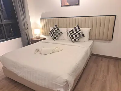 a bedroom with a large white bed with pillows at Agile marigold Suite KL in Kuala Lumpur