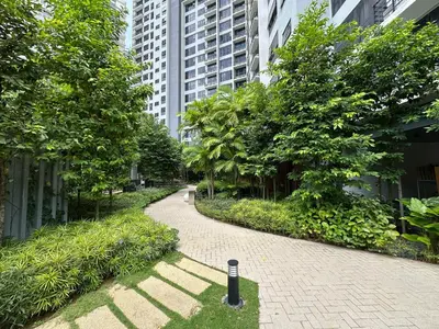 a walkway in a city with trees and buildings at Agile Bukit Bintang TRX KL by Lilbean Space - 2B1R in Kuala Lumpur