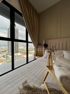 a bedroom with a bed and a large window at Trion KL By Couple stay in Kuala Lumpur