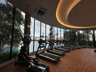 a gym with a row of treadmills in a building at Trion KL By Couple stay in Kuala Lumpur