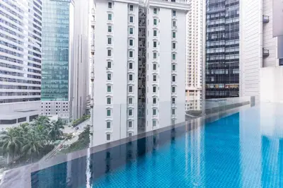 a pool in the middle of a building with tall buildings at Binjai 8 Signature by PSM in Kuala Lumpur