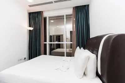 a bedroom with a white bed and a mirror at Binjai 8 Signature by PSM in Kuala Lumpur