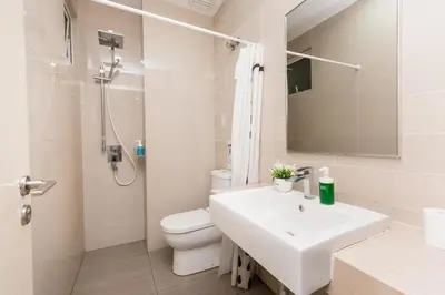 a white bathroom with a sink and a toilet at Binjai 8 Signature by PSM in Kuala Lumpur