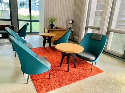 a group of chairs and tables in a room at The Mews Glorious Suites KLCC in Kuala Lumpur