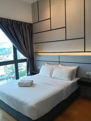 a bedroom with a bed with a large window at Colony by infinitum KLCC in Kuala Lumpur