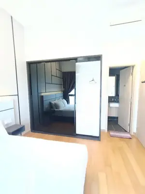 a view of a room with a bed through a window at Colony by infinitum KLCC in Kuala Lumpur