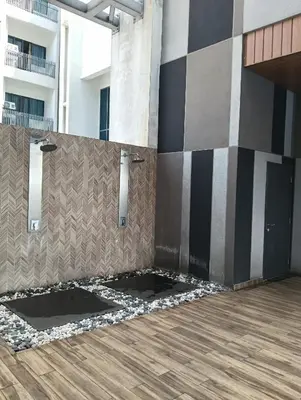 a bathroom with black and white walls and a wooden floor at Colony by infinitum KLCC in Kuala Lumpur