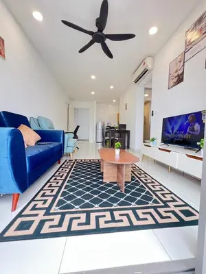 a living room with a blue couch and a ceiling fan at Cozy 2BR 2BR 2-5 Pax Kenwingston KL Genting View & Parking & Netflix 4505 in Kuala Lumpur