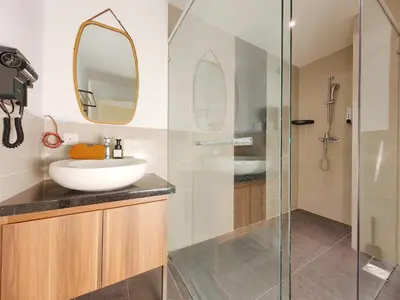 a bathroom with a sink and a glass shower at The Aspire - Bangsar Trade Centre in Kuala Lumpur