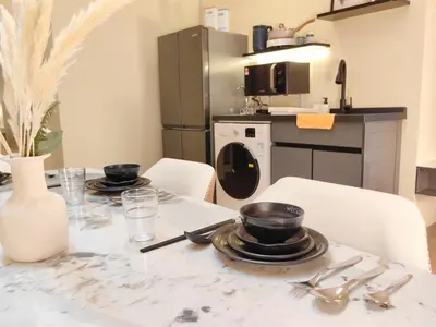 a table with plates and utensils on a kitchen at The Aspire - Bangsar Trade Centre in Kuala Lumpur