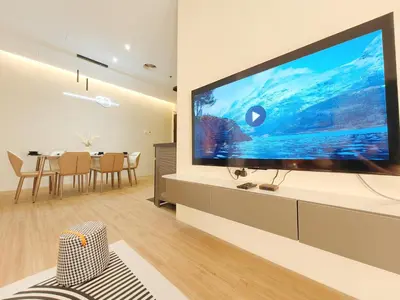 a living room with a large flat screen tv on a wall at The Aspire - Bangsar Trade Centre in Kuala Lumpur