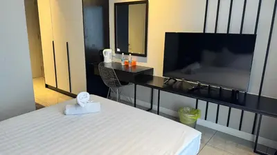 a hotel room with a bed and a flat screen tv at AXON Residence Near TRX & Pavilion KL in Kuala Lumpur