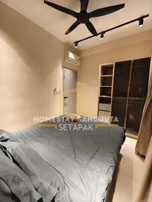 a bedroom with a ceiling fan and a bed at Homestay SANGJUTA Setapak - Kid Friendly in Kuala Lumpur