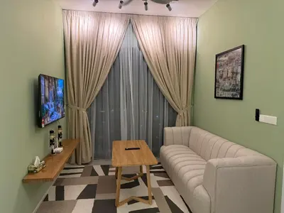 a living room with a couch and a table at Cozy Urban Retreat in the Heart of the Bangsar in Kuala Lumpur