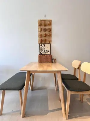 a wooden table with two chairs and a basket on top at Cozy Urban Retreat in the Heart of the Bangsar in Kuala Lumpur