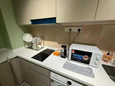 a kitchen with a microwave on a counter at Cozy Urban Retreat in the Heart of the Bangsar in Kuala Lumpur