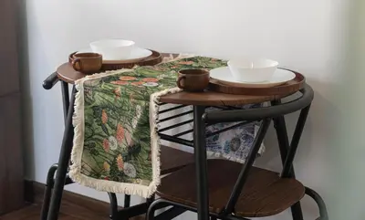 a table with bowls and cups on top of it at Cozy Studio l Riveria City l 1km to KL Sentral in Kuala Lumpur