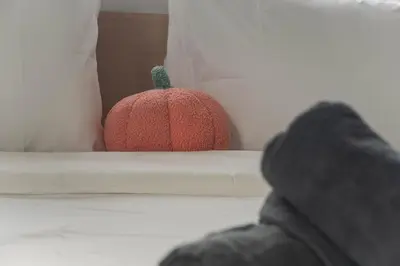a red pumpkin sitting on top of a bed at Cozy Studio l Riveria City l 1km to KL Sentral in Kuala Lumpur