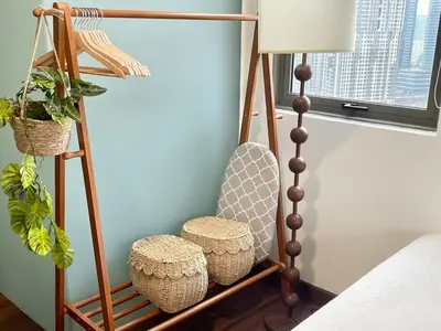 a room with a wooden shelf with baskets and a lamp at Cozy Studio l Riveria City l 1km to KL Sentral in Kuala Lumpur