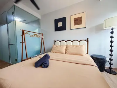 a bedroom with a large white bed with a lamp at Cozy Studio l Riveria City l 1km to KL Sentral in Kuala Lumpur