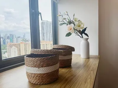 two baskets and a vase with flowers in a window at Cozy Studio l Riveria City l 1km to KL Sentral in Kuala Lumpur