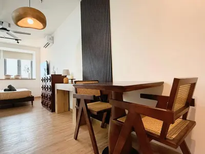 a living room with a wooden table and chairs at Cozy Studio l Riveria City l 1km to KL Sentral in Kuala Lumpur