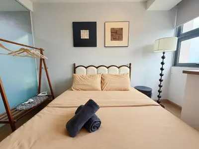 a bedroom with a bed with two towels on it at Cozy Studio l Riveria City l 1km to KL Sentral in Kuala Lumpur