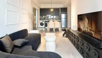 a living room with a couch and a dining room at Cozy Unit l Agile BB l 5min walk to TRX Pavilion in Kuala Lumpur