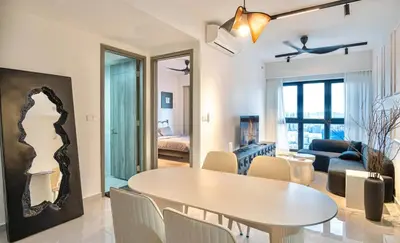 a dining room and living room with a table and chairs at Cozy Unit l Agile BB l 5min walk to TRX Pavilion in Kuala Lumpur