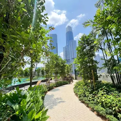 a walkway in a park with trees and buildings at Cozy Unit l Agile BB l 5min walk to TRX Pavilion in Kuala Lumpur