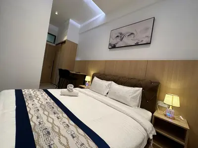 a bedroom with a large bed with white sheets at Vortex Suites Klcc by BEST TO BEST in Kuala Lumpur