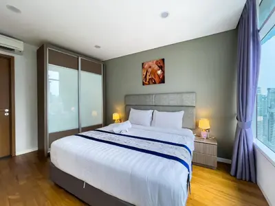 a bedroom with a large bed and a large window at Vortex Suites Klcc by BEST TO BEST in Kuala Lumpur