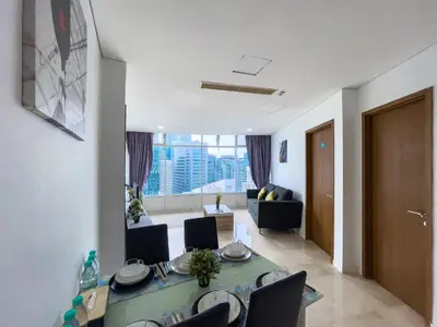 a living room with a table and chairs and a couch at Vortex Suites Klcc by BEST TO BEST in Kuala Lumpur